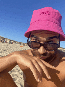 a man wearing a pink levi 's bucket hat