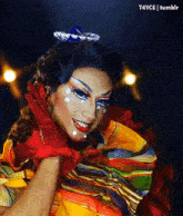 a drag queen is wearing a sombrero and a colorful dress and gloves .