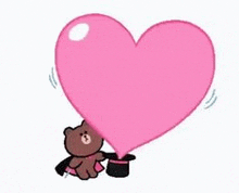 a brown teddy bear is holding a pink heart balloon .