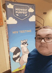 a man holding a sign that says welcome to midwest furfest 2018 hiv testing