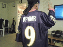 a person wearing a purple jersey with the name mcnair on it