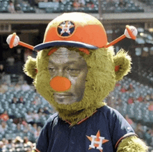 a mascot for the astros is wearing a hat