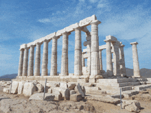 a row of columns with a blue sky behind it