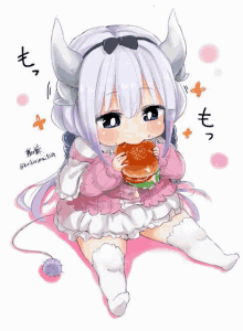 a little girl with horns is eating a hamburger while sitting on the floor .