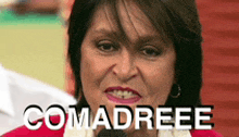 a woman in a red sweater with the word comadreee written on it