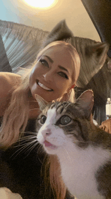 a woman is posing for a picture with her cat