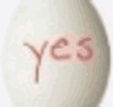 the word yes is written on a white egg .