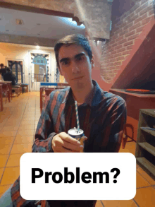 a man holding a can of soda with a straw and the word problem behind him