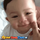 a picture of a baby with the words star tamilchat.in