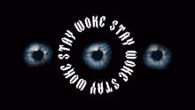 a poster that says stay woke and shows three eyes