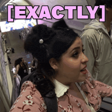 a woman with a bow in her hair has the word exactly above her head