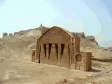 a desert landscape with a building in the middle of it