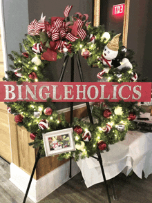 a wreath on a stand with a sign that says bingleholics