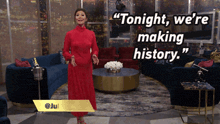 a woman in a red dress says " tonight we 're making history " while standing in a living room
