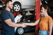 a man shakes hands with a woman in front of a car