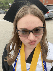 a woman wearing a graduation cap and gown with a yellow medal that says national honor society