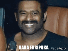 a man with a mustache is smiling and holding a microphone with the words haha erripuka face app written below him