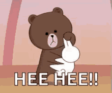 a brown teddy bear is holding a white rabbit and says `` hee hee '' .