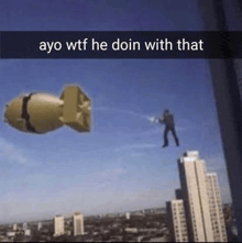 a man is flying through the air next to a large bomb .