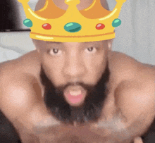 a man with a beard is wearing a crown over his head