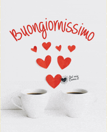 two cups of coffee on a table with hearts and the words buongiornossimo