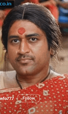 a man with a red bindi on his forehead and a follow button