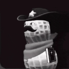 a peanut with a cowboy hat and mustache is holding a book .