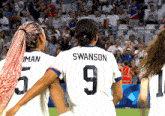 a soccer player with the name swanson on her back