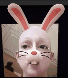 a man with bunny ears on his face looks at the camera