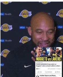 a man is holding a nuggets vs lakers ad in front of him