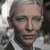 a close up of a woman 's face with a smile