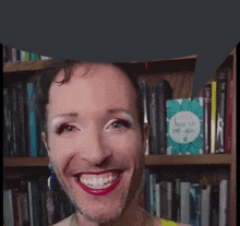 a woman is smiling in front of a bookshelf with a speech bubble that says " how to be you "