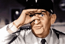 a man in a police uniform is covering his eyes with his hands