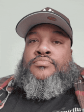 a man with a beard wearing a hat and a shirt that says ' faith ' on it