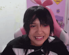 a girl with bunny ears on her head is smiling in front of a king sign