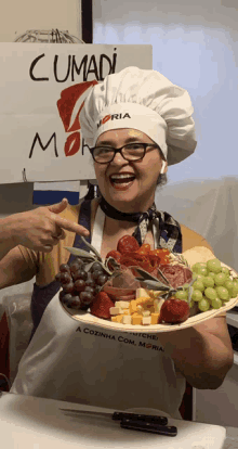 a woman wearing a chef 's hat holds a plate of food