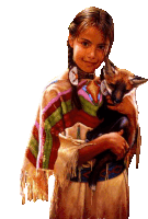 a girl in a native american outfit is holding a fox in her arms