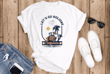 a white shirt that says let 's go holiday on it