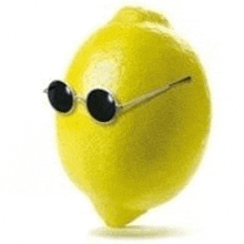 a lemon wearing sunglasses on a white surface .