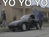 a black car is parked on the side of the road with the words yo yo yo in white letters