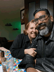 a man and woman are posing for a picture with a glass that says ' coca cola ' on it