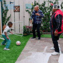 a group of men are playing soccer in a backyard with a sign in the background that says " the house on the park "