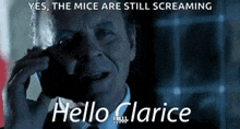 a man in a suit and tie is talking on a cell phone and says hello clarice .