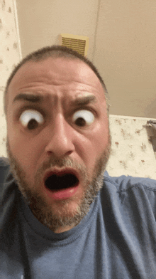 a man with a beard making a surprised face