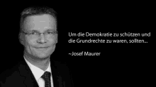 a black and white photo of a man in a suit and tie with a quote from josef maurer