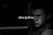 a man in a suit and tie is sitting in a car and the word discipline is visible