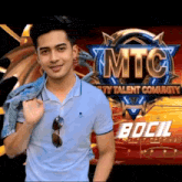 a man stands in front of a mtc logo