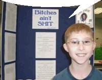 a boy is smiling in front of a sign that says bitches ain 't shit