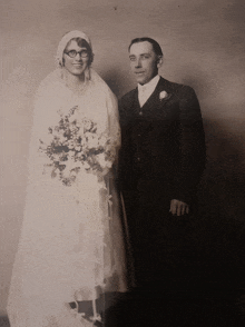 a bride and groom pose for a photo on their wedding day
