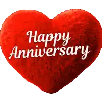 a red heart shaped pillow says happy anniversary
